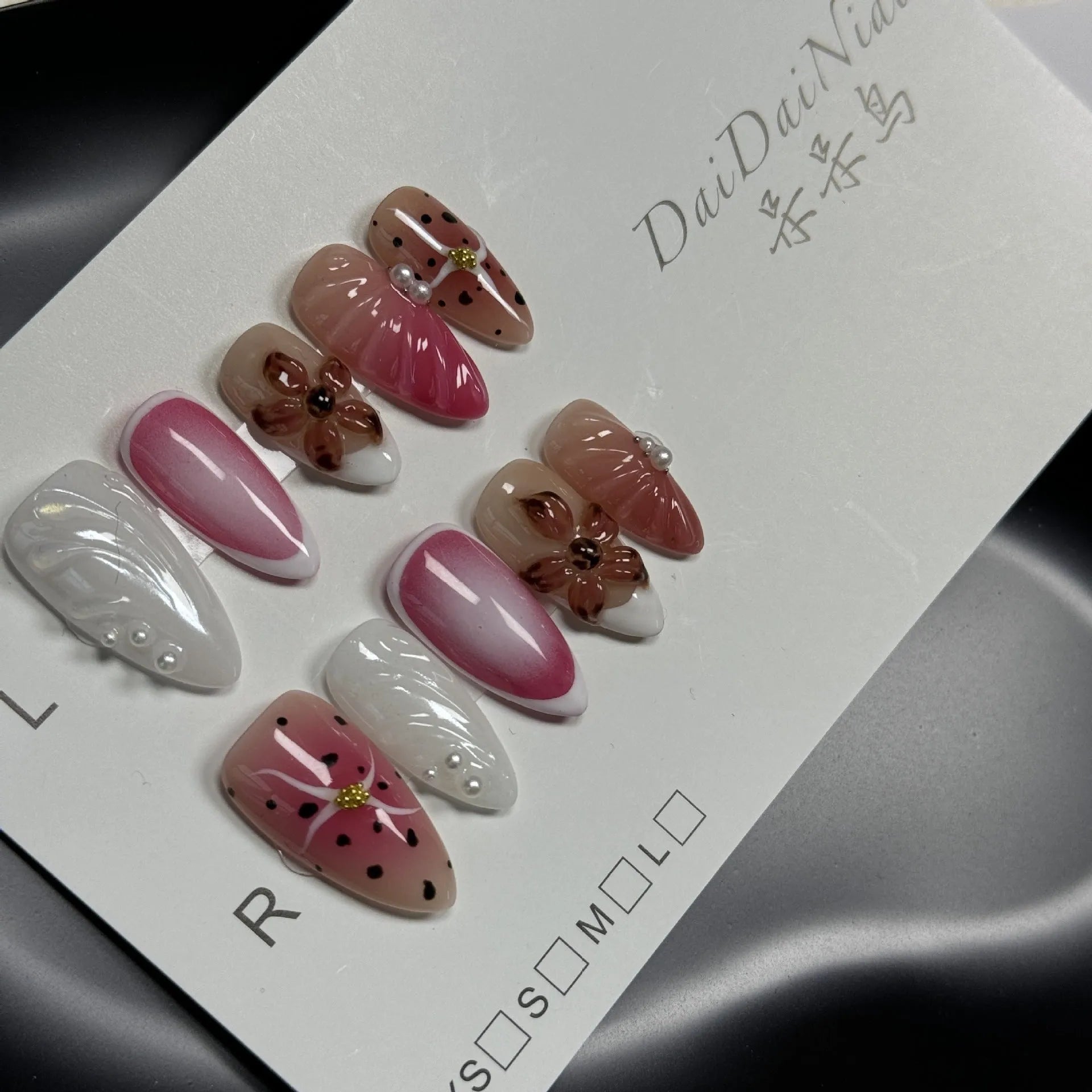 Hand-painted three-dimensional carved nail beauty patches in candy colours on an almond-shaped nail.