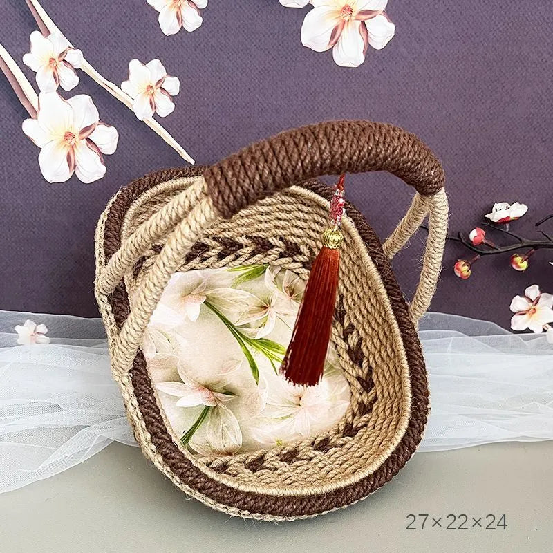 A hand-woven straw basket in a coffee brown colour, measuring 19cm by 12cm.