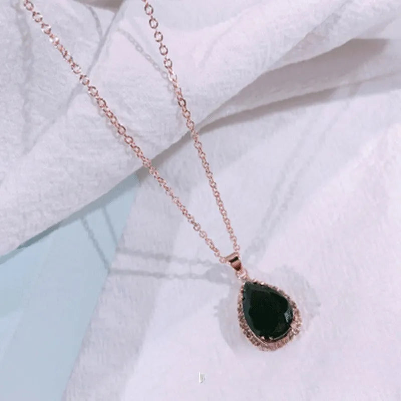 Women's water drop necklace with rose gold rhinestone and pink alloy gemstone pendant.