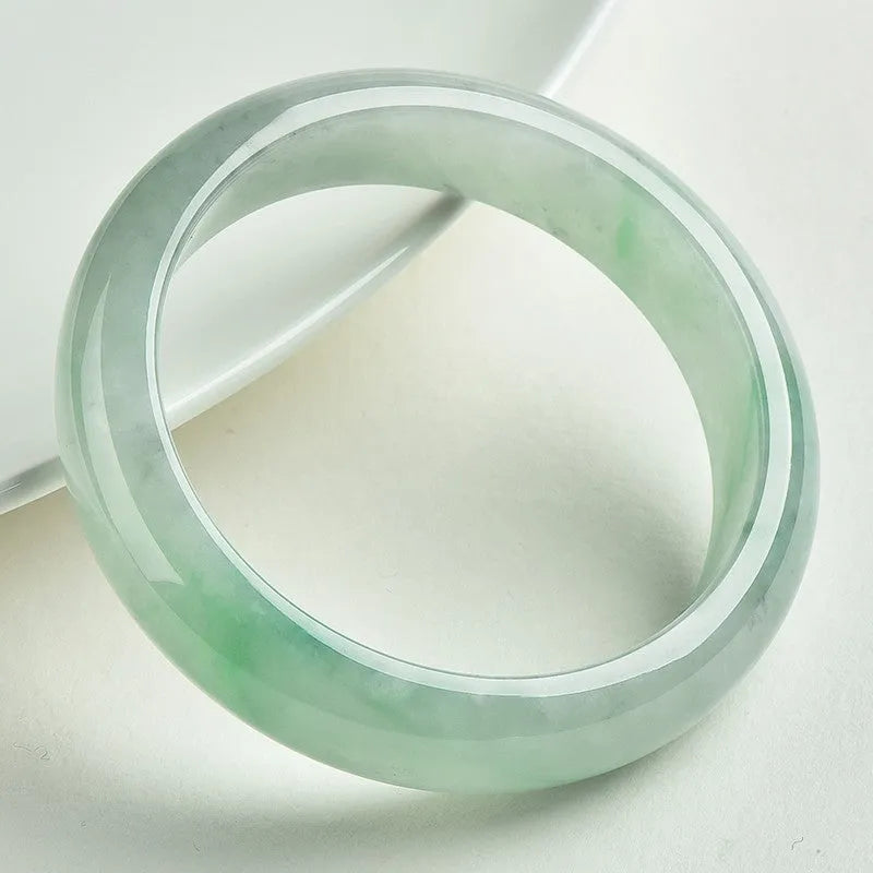 Light green jade bracelet with natural style design on wrist