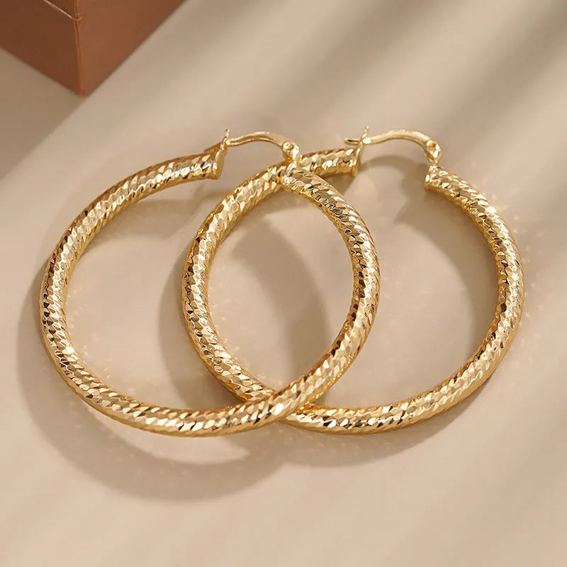 Geometric ring design drop-shaped ear clip earrings for women in a metallic electroplated finish.