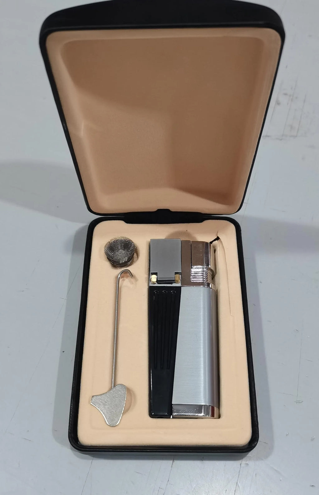 Silver and black foldable metal pipe lighter showing open and closed positions with refillable butane valve