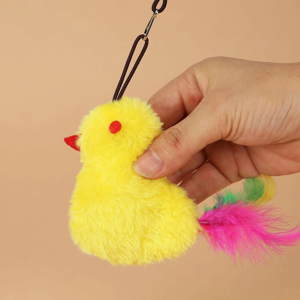 Retractable cat teaser toy hanging on door frame with dangling mouse toy and treat reward bulb