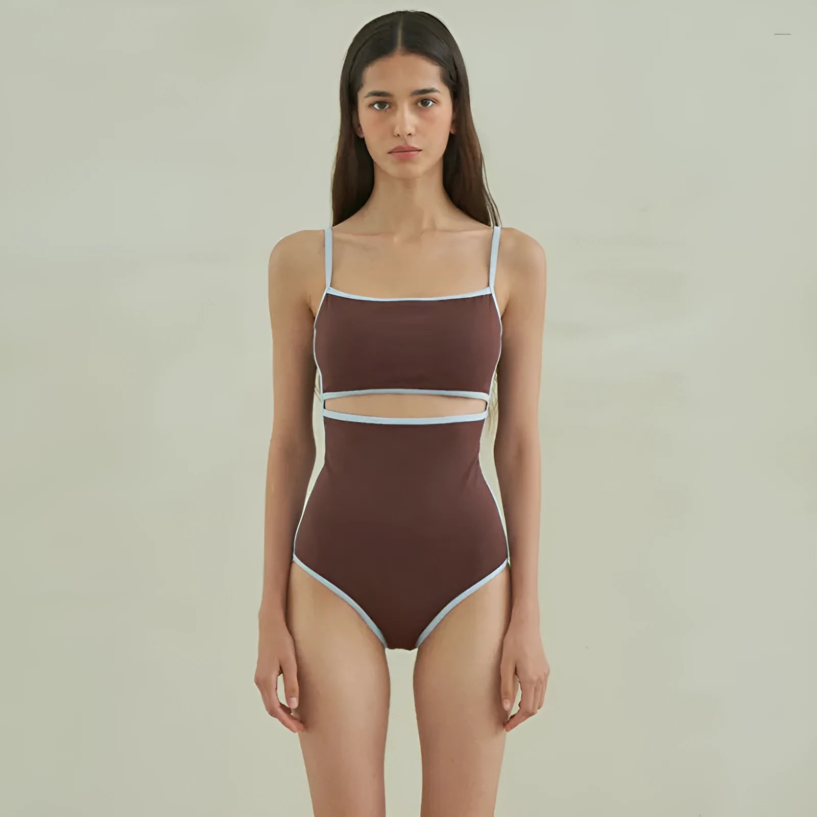 Brown women's one-piece swimsuit with triangle neckline on a hanger.