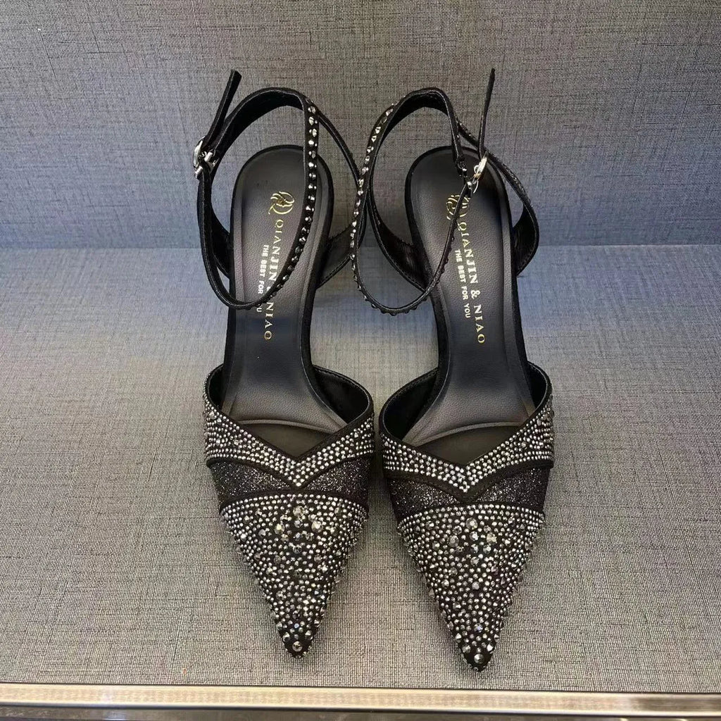 Women's black stiletto heels with pointed toe, hollowed design and red sole