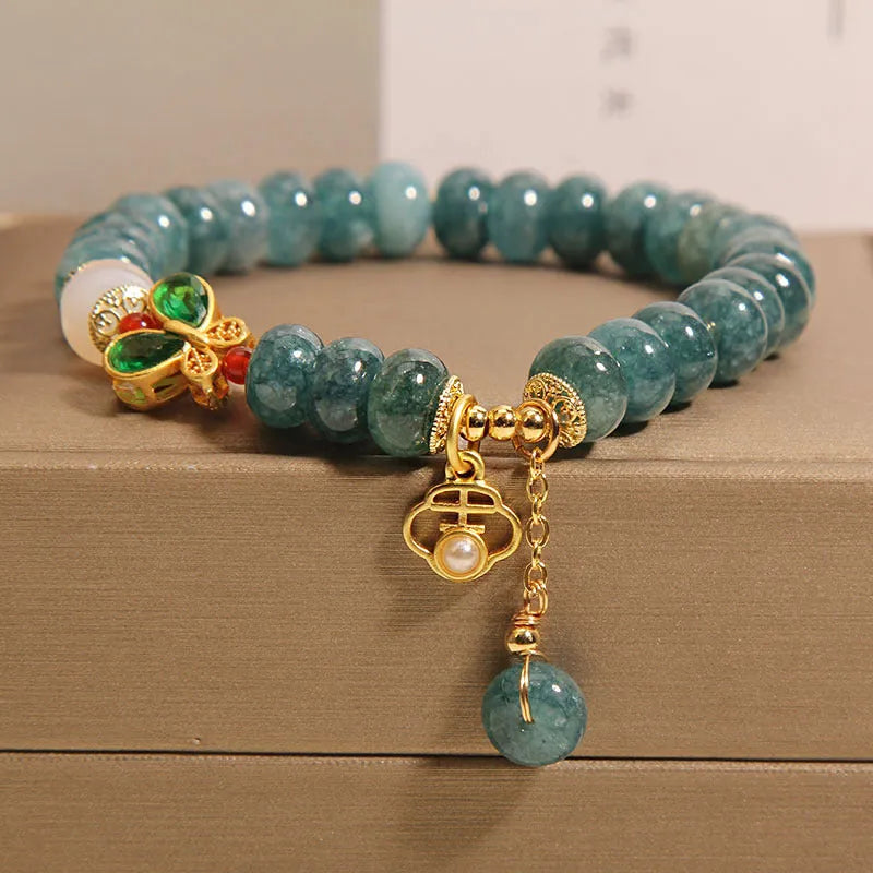 Blue water jade and white agate abacus bead crystal bracelet with rhinestone details and butterfly motif on alloy base