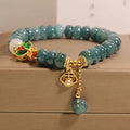 Blue water jade and white agate abacus bead crystal bracelet with rhinestone details and butterfly motif on alloy base