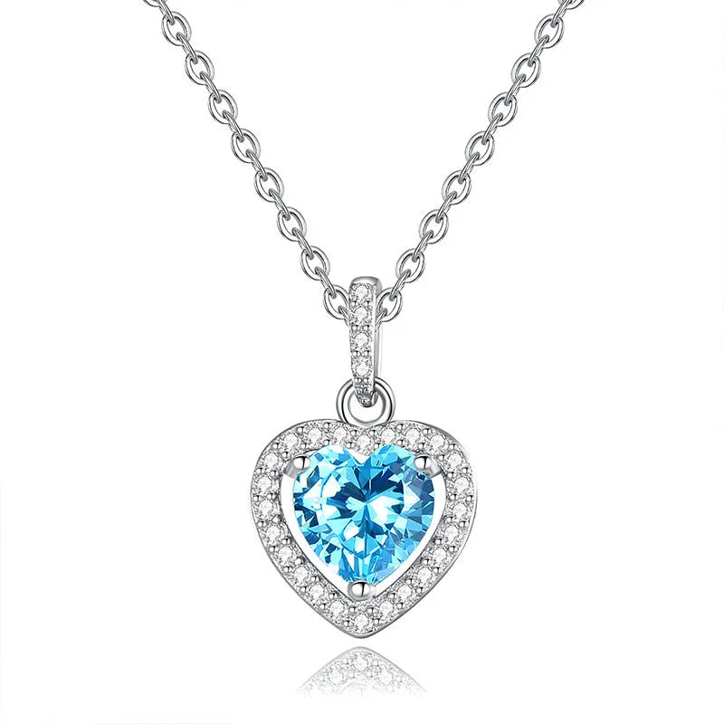 Women's sterling silver necklace with a heart-shaped amethyst pendant on an adjustable cross chain.