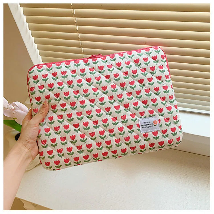 Printed floral design cloth laptop bag for women shown in small, medium, and large sizes.