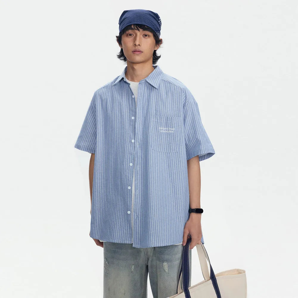 Blue and white striped loose-fitting short-sleeved shirt on a hanger