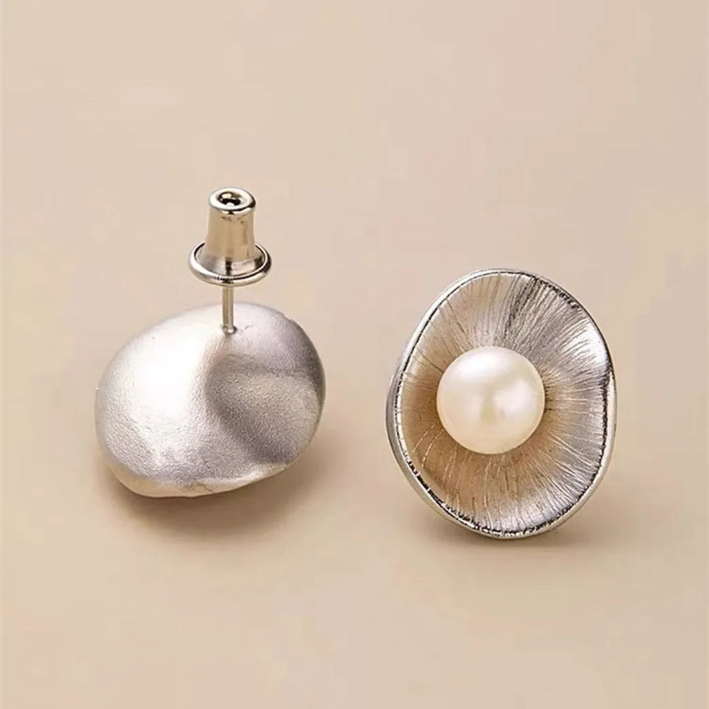 Gold-coloured geometric pearl stud earrings made from sterling silver with electroplated finish