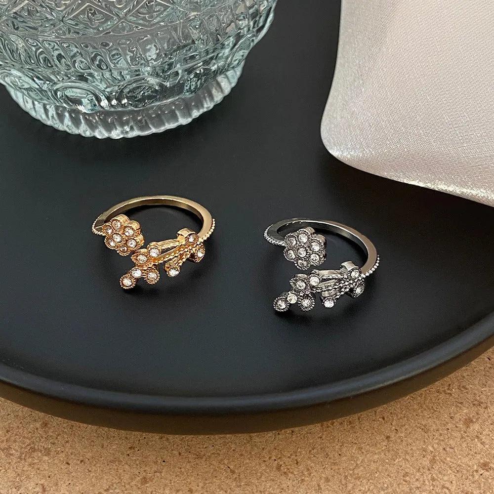 Copper open ring with diamond-treated floral and leaf decoration in gold colour