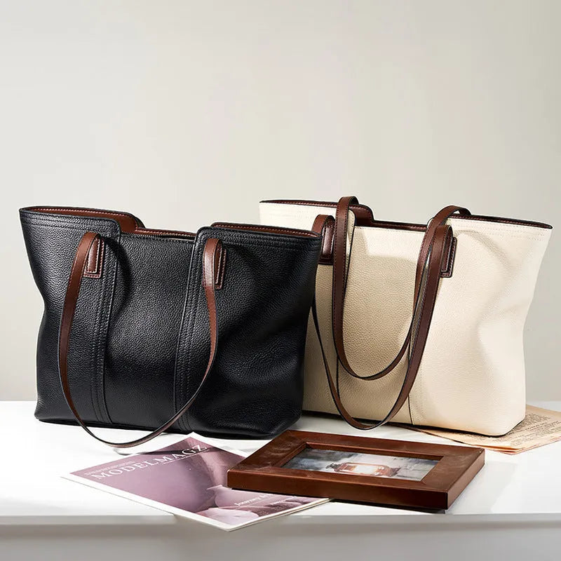Women's black genuine leather commuter bag with crossbody strap and internal organiser pockets