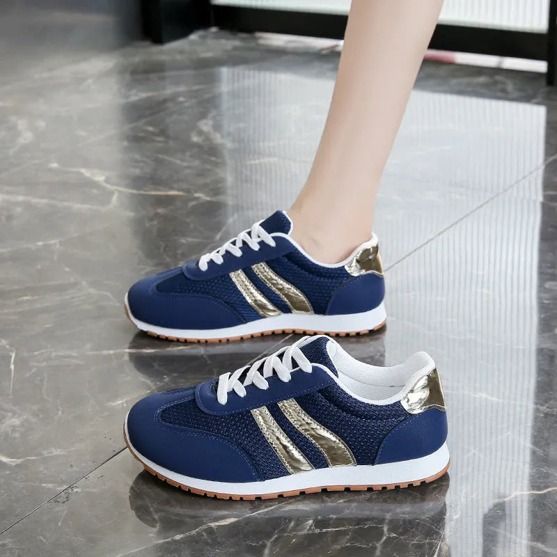 Blue women's casual tennis shoes with cross straps and a white rubber sole.
