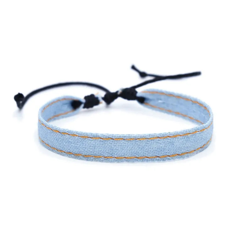 Denim fabric bracelet carrying strap with mixed materials and unisex design
