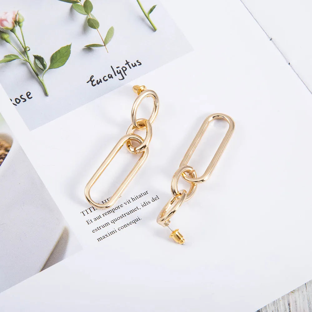 Geometric sterling silver coloured alloy hoop earrings for women with a ring and line design.