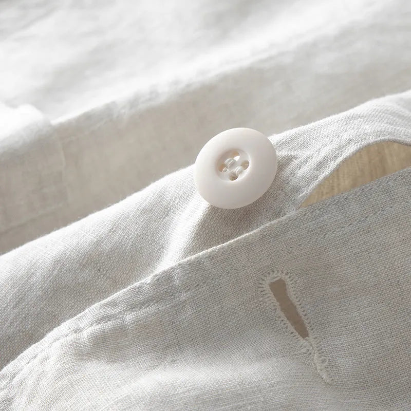 Men's casual linen suit jacket in a solid colour on a hanger, showing long sleeves and loose fit.