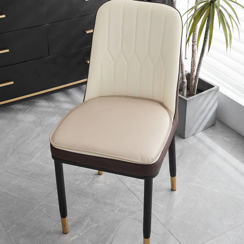 Brown leather horseshoe-shaped seat cushion on a wooden chair, showing non-slip base.