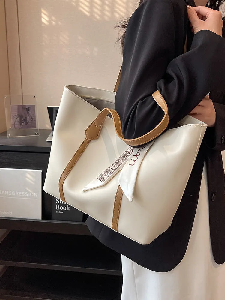 Women's soft large capacity tote bucket shoulder bag in khaki colour showing crossbody strap and front sandwich pocket.