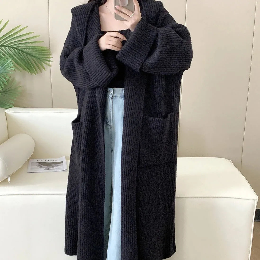 Loose hooded cardigan coat with raglan sleeves in acrylic fabric showing extended length