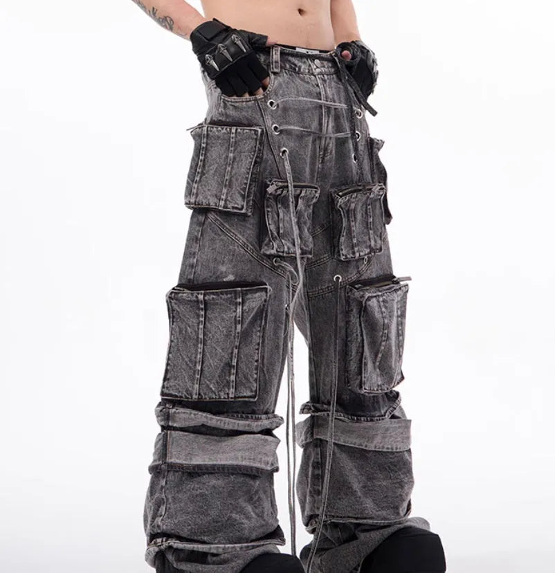 Grey distressed denim overalls with rope stitching on a hanger.