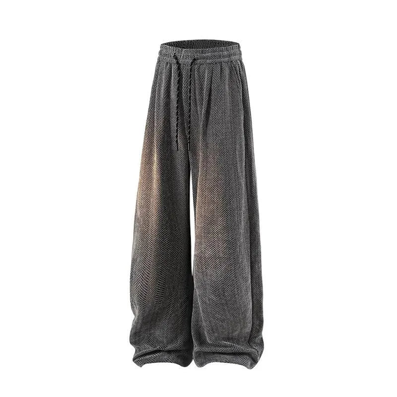 Man's straight-leg fleece-lined trousers in black with an elastic waistband, showing hollow-out fabric texture.