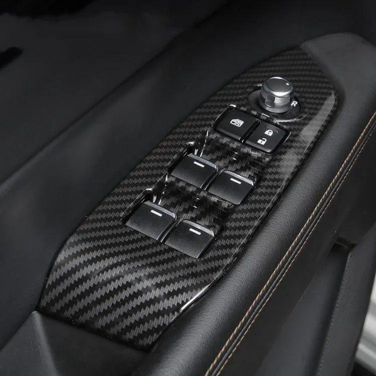 Carbon fibre decorative left and right steering wheel frame trim panels for car interior.