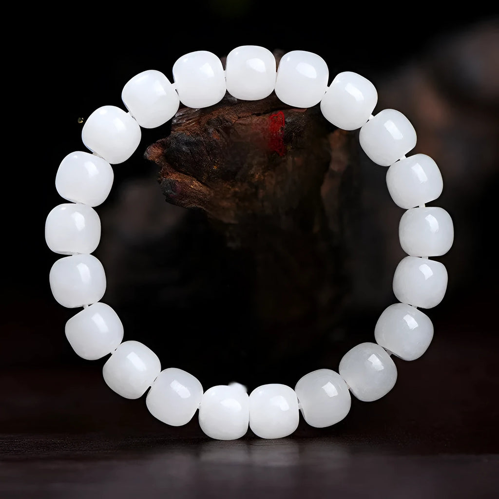White Hetian jade barrel bead bracelet on a wrist, showing unisex casual style
