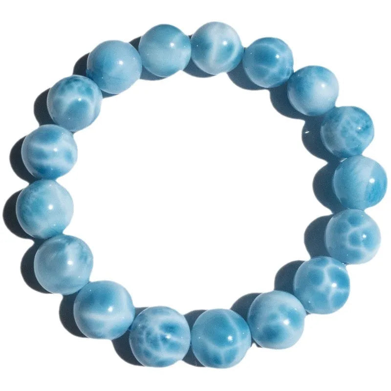 Blue Bodhi bracelet with natural sea-pattern crystal bead and pearl details in Maillard style.