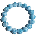 Blue Bodhi bracelet with natural sea-pattern crystal bead and pearl details in Maillard style.