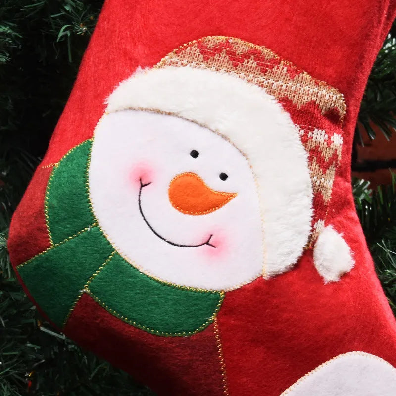 Red Christmas stocking with elk, old man and snowman printed designs in traditional American style
