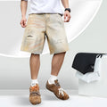 Men's light blue ripped denim shorts with straight leg style and mid-waist fit