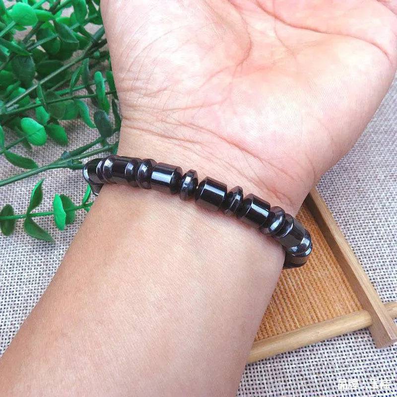 Black magnetic therapy bracelet with a pentagram stone design made from magnetite and hematite.