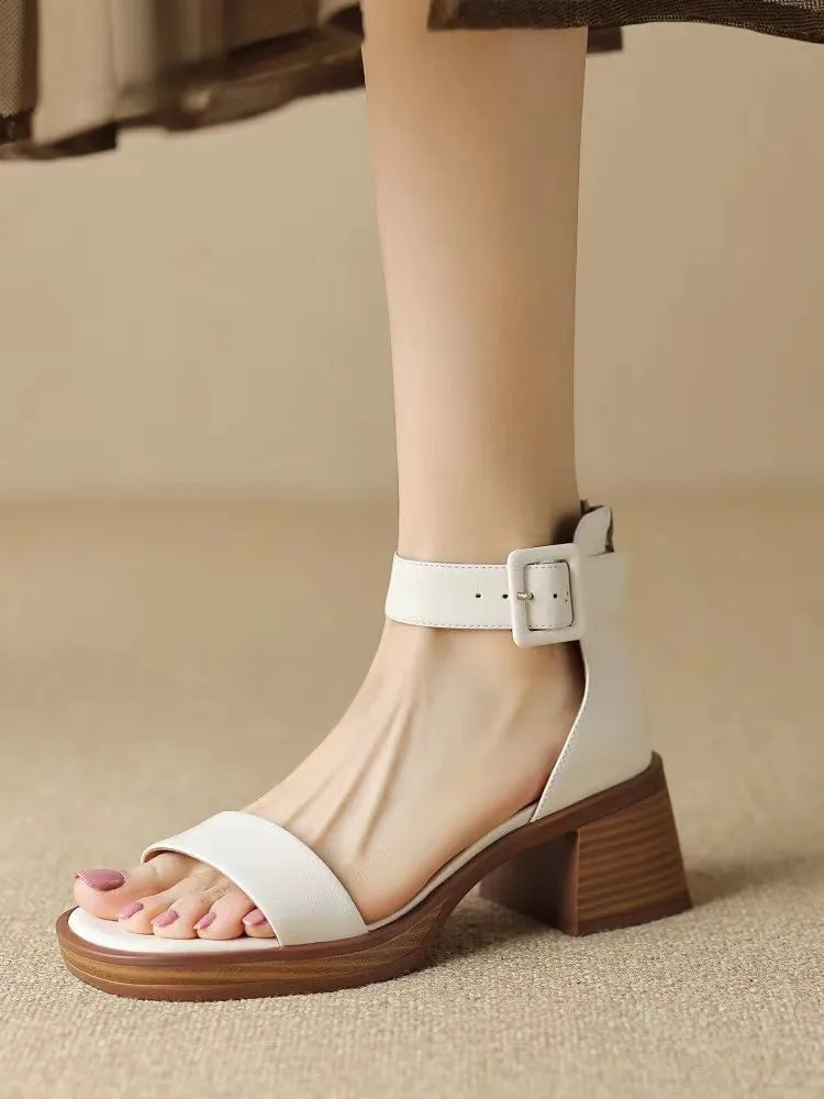 Women's white retro ankle-strap platform high heels with a round toe.