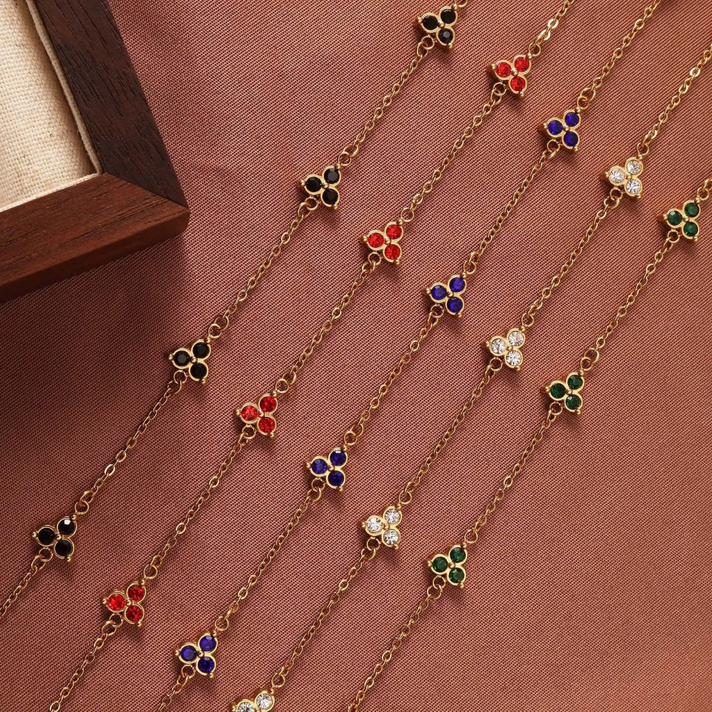 Geometric triangle bracelet for women in stainless steel with coloured zircon stones.