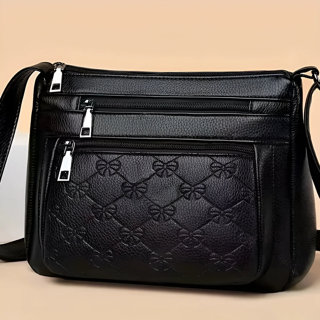 Butterfly black PU leather crossbody messenger bag showing embossed texture and sewing thread details
