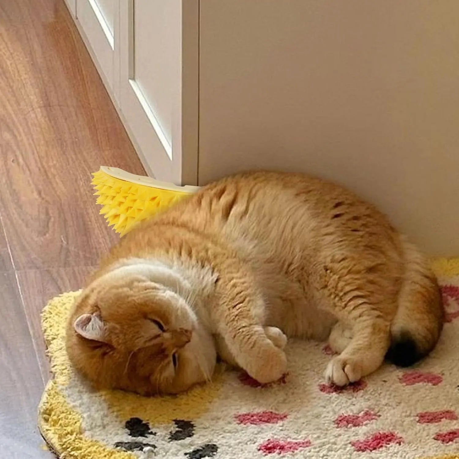 Yellow durian-shaped cat corner scratcher and grooming toy mounted on a wall.