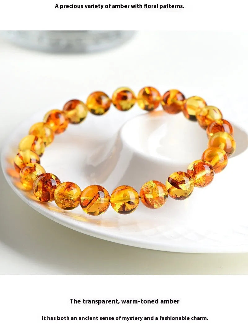 Natural yellow piebald amber bracelet with geometry beads on wrist