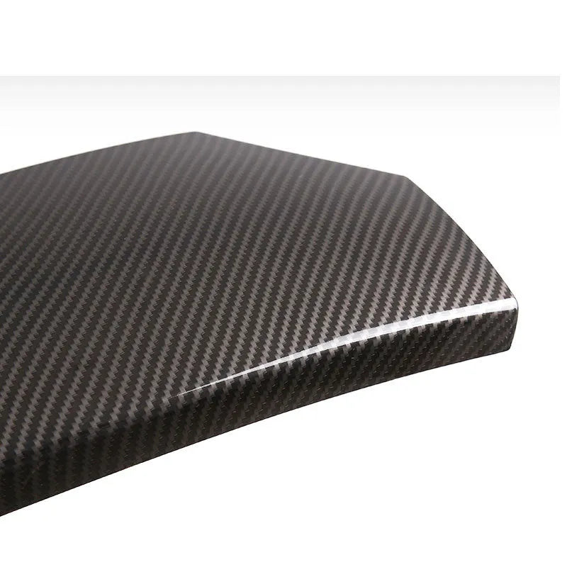 Set of three black ABS plastic armrest box covers with a shiny carbon fibre pattern.