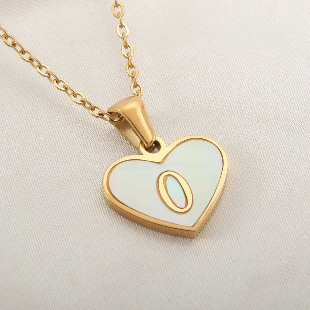 Gold plated initial necklace with white shell heart pendant and adjustable chain