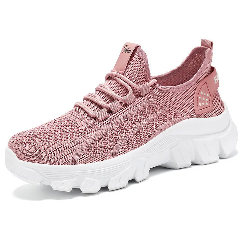 Women's white Flyknit running sneakers with a thick PVC sole and lace-up front.