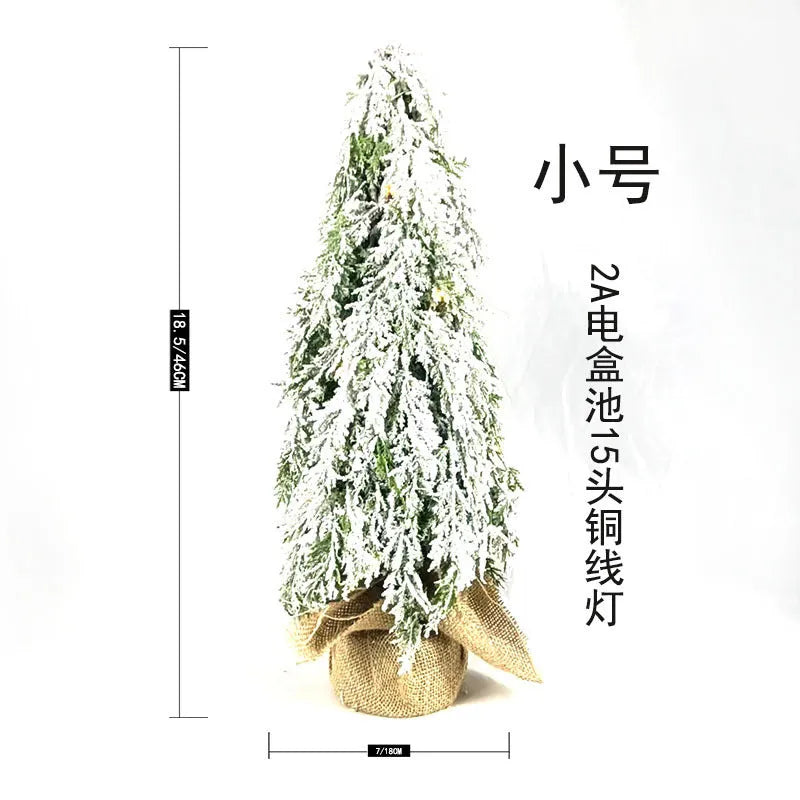24-inch white snowy plastic desktop Christmas tree with built-in lights and one ornament.
