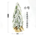 24-inch white snowy plastic desktop Christmas tree with built-in lights and one ornament.