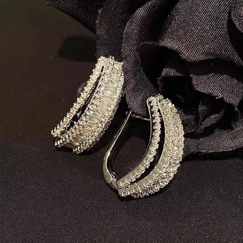 White gold coloured geometric stud earrings with zircon stone accents on copper metal for women