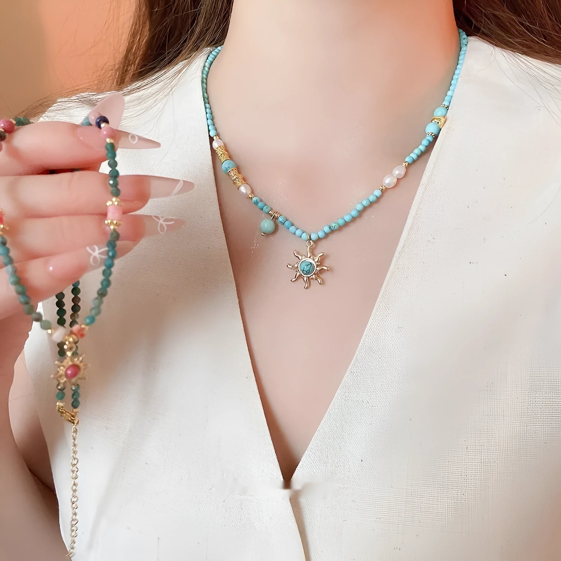 Freshwater pearl sun necklace with blue stone pendant on a gold-tone adjustable chain.