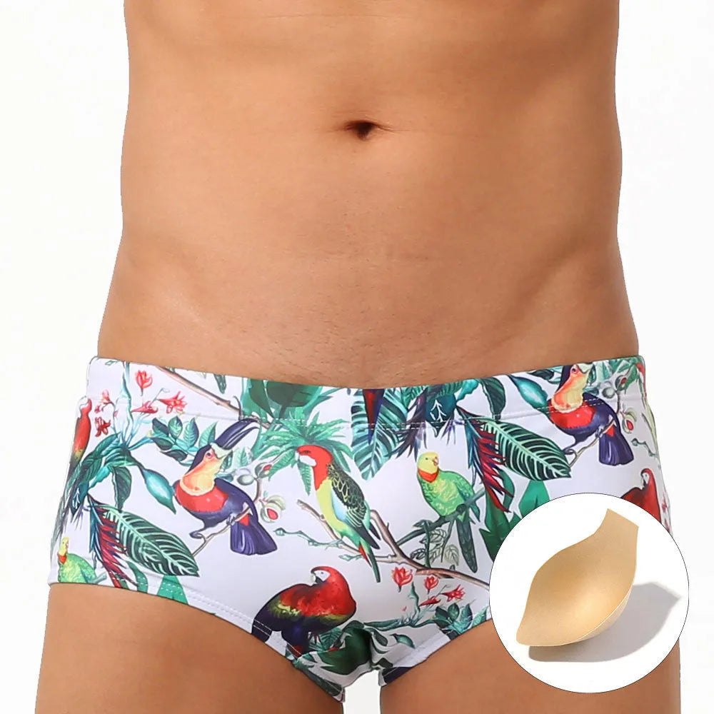Men's navy swim trunks with colourful flower and bird print pattern, boxer style