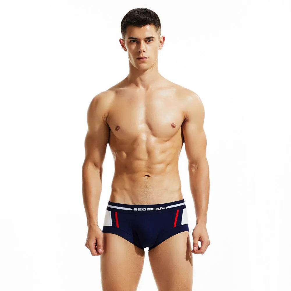 Men's cotton boxer shorts in red, dark blue, or light grey, showing low waist design