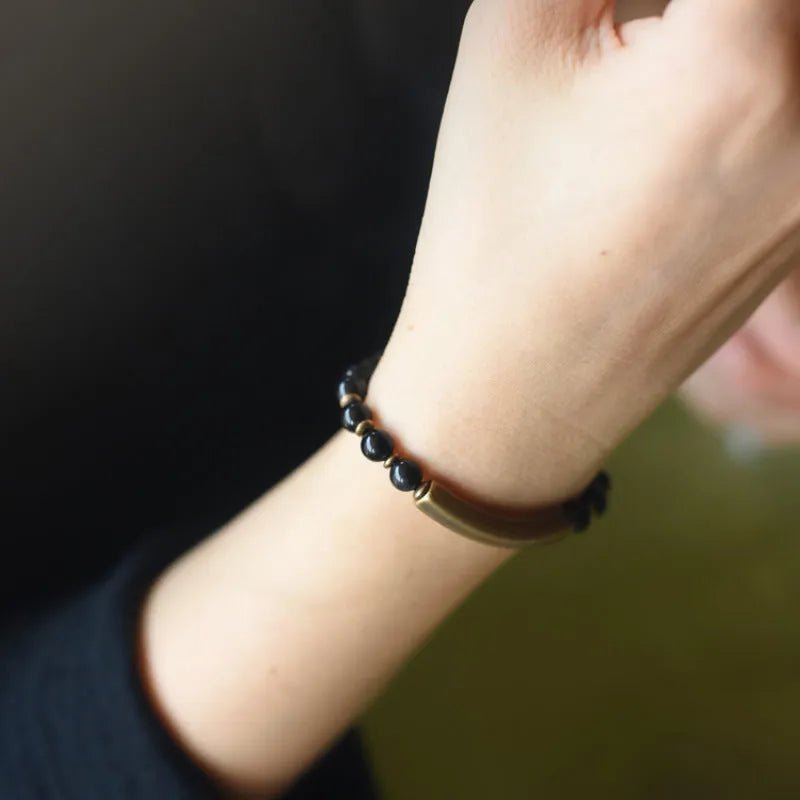 Layered ethnic bracelet in natural stone with brass detailing on wrist