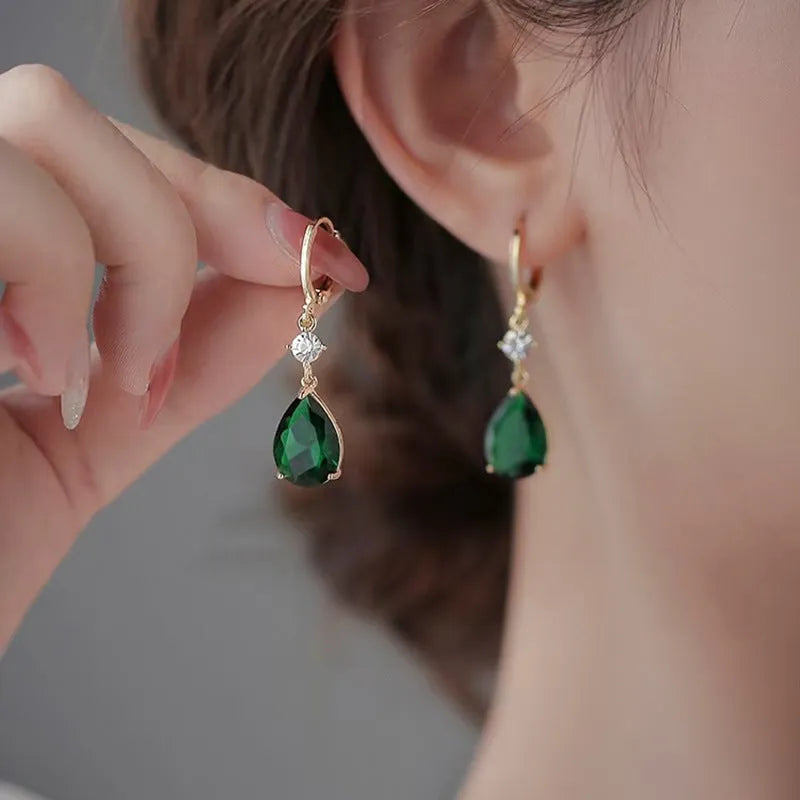 Green geometric teardrop alloy earrings with drop design on display