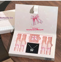 Butterfly Box makeup set showing four lip mud containers, powder blusher, and necklace in pink packaging